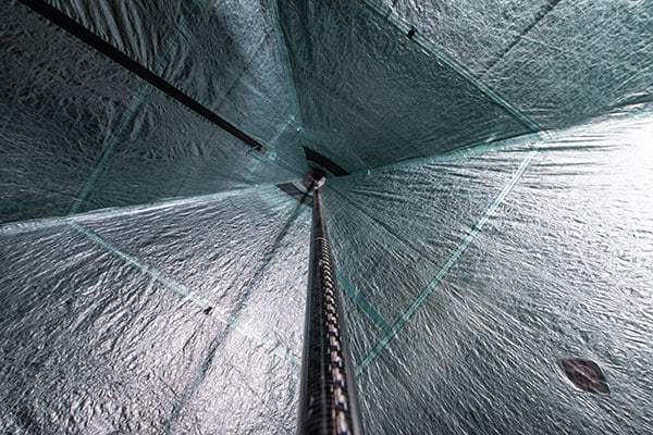 The inside of a tunnel covered in a green tarp.