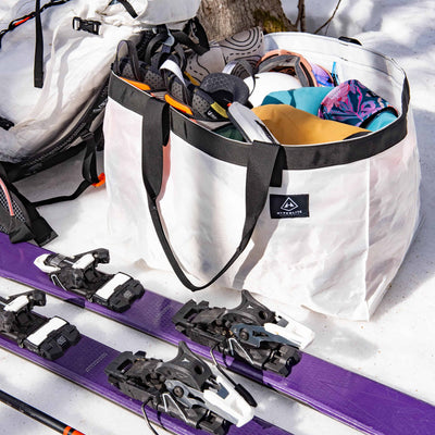 Overhead shot of Hyperlite Mountain Gear's G.O.A.T. Tote White with Skiing Gear