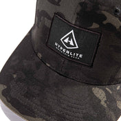 Detail shot of the Hyperlite Mountain Gear Logo on the Full Dome Hat in Multi Color Camo