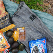 Hyperlite Mountain Gear's Stuff Pack 30 on the ground surrounded by food 