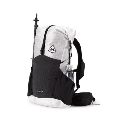 Front view of the Hyperlite Mountain Gear Waypoint 35 with a trekking pole in the Dyneema® Stretch Mesh front pocket