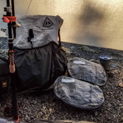 Two Hyperlite Mountain Gear Pods laying next to a pack inside of a tent