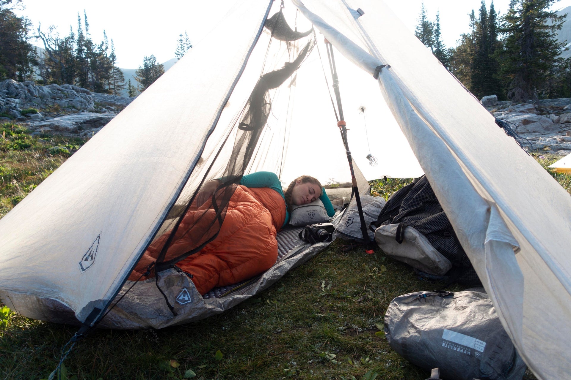 A woman lying in a tent.