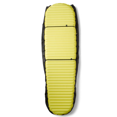The Hyperlite Mountain Gear 40 Degree Quilt strapped to a sleeping pad using the 2 separate pad attachment straps
