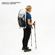 Left side view of Hyperlite Mountain Gear's Junction 55 Pack in White on model with poles