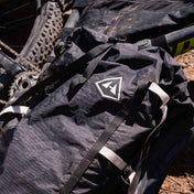 Front view of Hyperlite Mountain Gear's Porter 55 Pack in Black on the ground