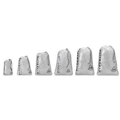 Front view of all sizes of Hyperlite Mountain Gear's Drawstring Stuff Sacks in White