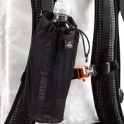 Front view of Hyperlite Mountain Gear's The Bottle Pocket attached to backpack by gatekeeper hitch lock