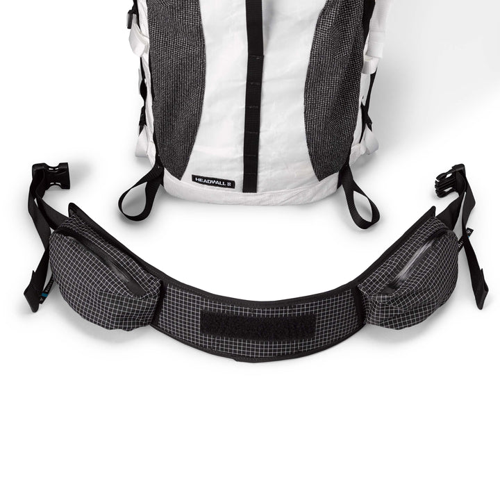 A white and black backpack with two straps.