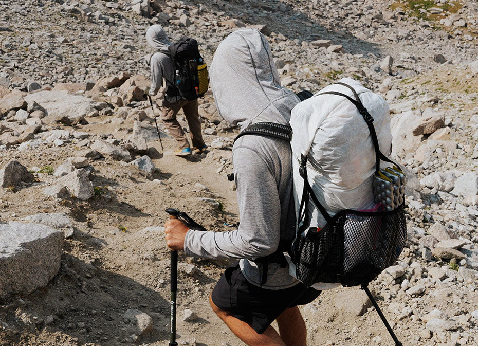 Hikers descend a rocky trail