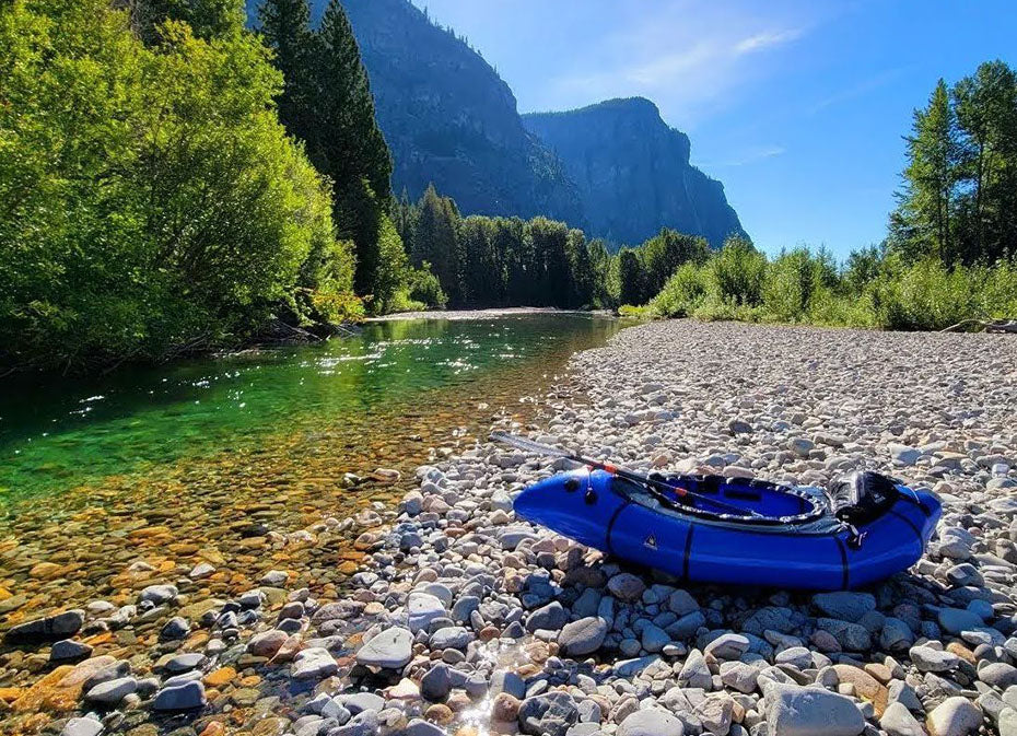 Packrafting setup on the bank of a river