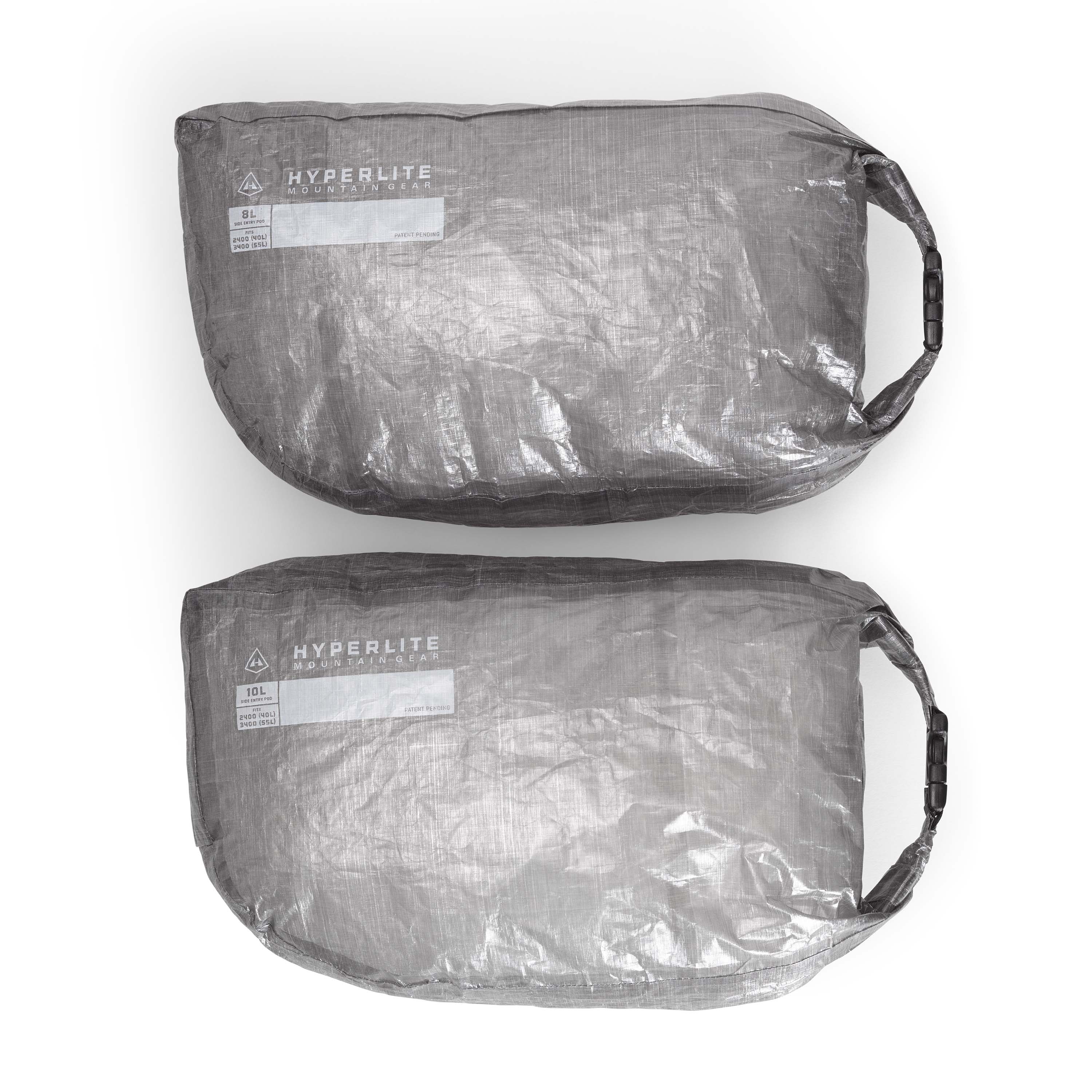 Two grey plastic bags on a white surface.