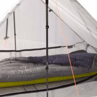 A tent with a sleeping bag inside of it.