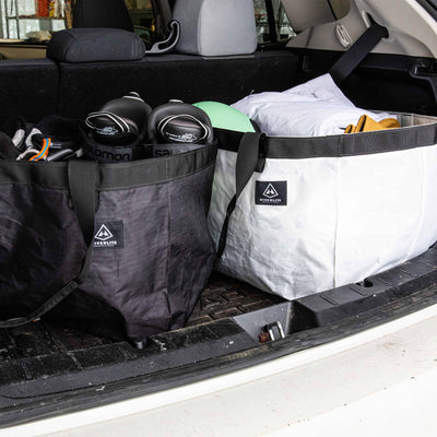 Black and White Hyperlite Mountain Gear G.O.A.T. Tote's in the trunk of a vehicle