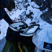Interior shot of Hyperlite Mountain Gear's Prism Ice Screw Case with climber on snowy mountain