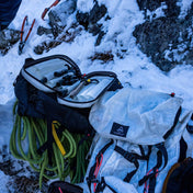 Over head shot of Hyperlite Mountain Gear's Prism Ice Screw Case in White on snowy mountain