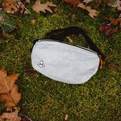 Overhead view of the Hyperlite Mountain Gear Vice Versa in White laying in the moss and leaves