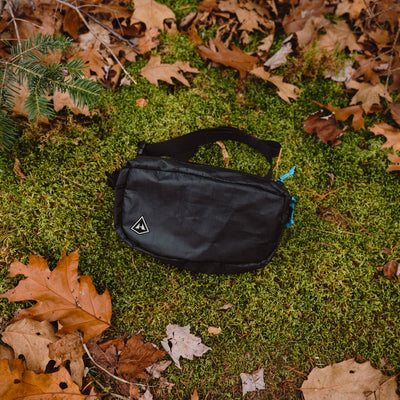 Overhead view of the Hyperlite Mountain Gear Vice Versa in Black laying in the moss and leaves