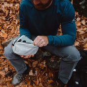 Hiker stashes their phone in the Hyperlite Mountain Gear Vice Versa in White