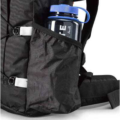 Detail shot of the angled side water bottle pocket on Hyperlite Mountain Gear's Daybreak 17 Pack in Black