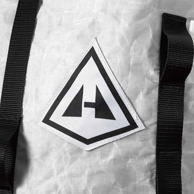 Detail shot of the Hyperlite Mountain Gear Logo on the front of the Porter 85 Pack in White