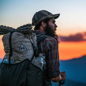 Bearded hiker reaching the summit with the Southwest 55 backpack
