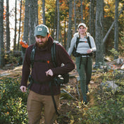 Hikers on a wooded trail wearing the Hyperlite Mountain Gear Unbound 40 Pack
