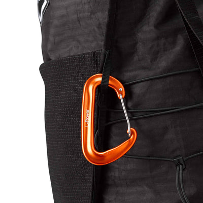 Side view of the Hyperlite Mountain Gear Unbound 40 with a carabiner attached to one of four 1/4" vertical daisy chains