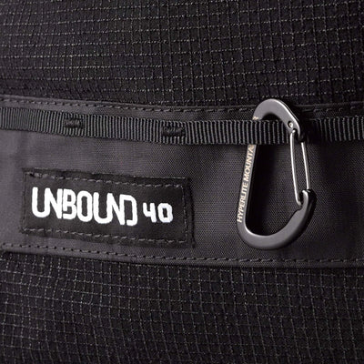 Close up of the Hyperlite Mountain Gear Unbound 40 with product patch and horizontal daisy chain below dual-entry front pocket
