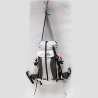 A white backpack hanging on a white background.
