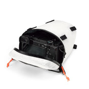 The Hyperlite Mountain Gear Camera Pod open showing a camera tucked inside