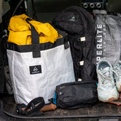 Front view of Hyperlite Mountain Gear's G.O.A.T. Tote with hiking gear in the trunk of a vehicle