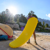 Camper blowing up Hyperlite Mountain Gear's Therm-a-Rest NeoAir® XLite™ NXT Sleeping Pad