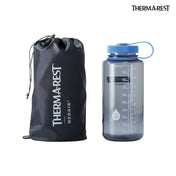 A size comparison showing the packed up Therm-a-Rest NeoAir® XTherm™ NXT Sleeping Pad just larger than a Nalgene water bottle
