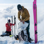 Two skiiers unload their gear from the Hyperlite Mountain Gear Headwall 55 in preparation to ski
