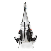 Hyperlite Mountain Gear Headwall 55 with two skis attached using the A-frame carry via the dual adjustable side compression straps