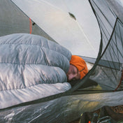 Camper sleeping in the Hyperite Mountain Gear 20 Degree Quilt