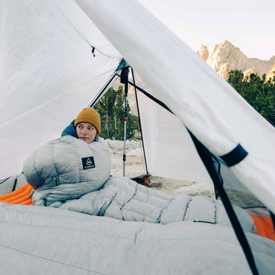Camper wakes up in the morning in their Hyperlite Mountain Gear 20-Degree Quilt