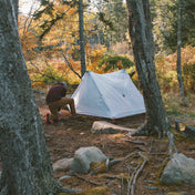 Camper sets up the Hyperlite Mountain Gear Unbound 2P Tent at camp
