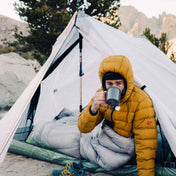 Bundled up camper enjoys some warm tea in the Hyperlite Mountain Gear Unbound 2P Tent