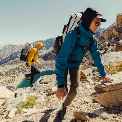 Two hikers hit a minor rock scramble on their way to the summit using the Hyperlite Mountain Gear Unbound 40 Pack